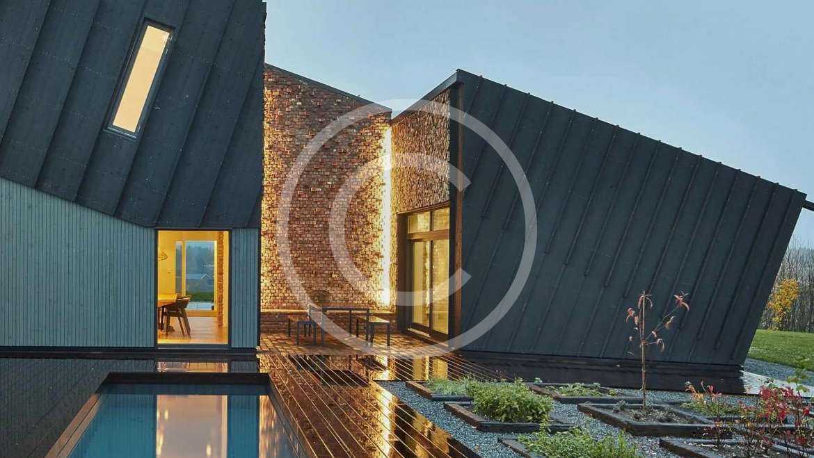 In-ground pool design using brick with gazebo & outdoor furniture setting